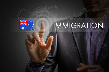 Australia immigration concept. Man pressing virtual button with flag icon