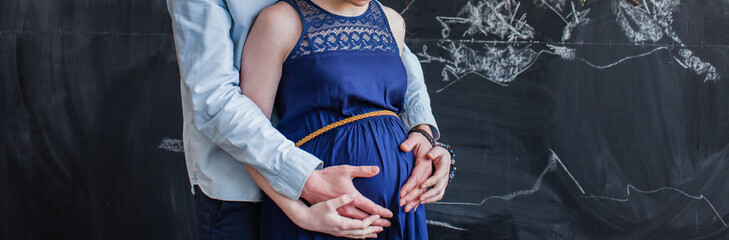 Man embraces his pregnant woman