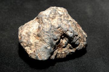 Iron-stone meteorite on a black background