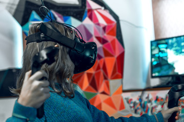 The girl with the helmet is playing a 3D game