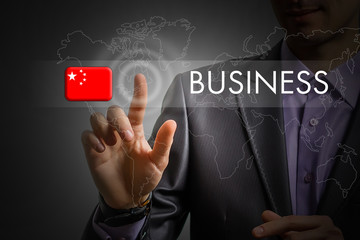 China Business concept. Man pressing virtual button with flag icon