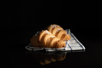 sprinkle Croissant Saree Flour on white towel  with black background