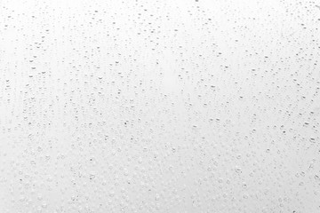 Raindrop water dew drop on glass wet white gray blue background.