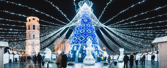 Vilnius, Lithuania, 2019: Beautiful Christmas tree decorated with white and blue lights chess queen...