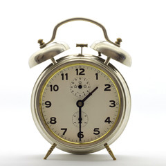 Old-style alarm clock, metal, it's half past one.