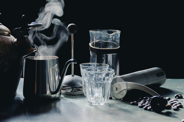 Aromatic coffees in French press coffee maker with couple glass and Antique coffee bean grinder using hand crank,Hot drink is good for health,Wood table,Black background,Natural light,Healthy Eating.
