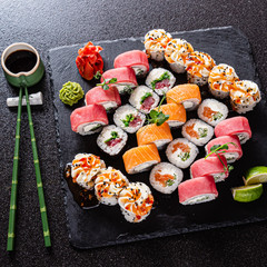fresh and tasty sushi on the black background
