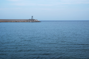 Concrete pier and calm sea, nobody. Adriatic, Italy.