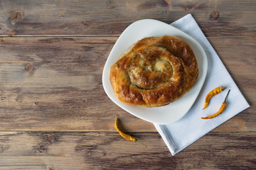 Balkan cuisine. Burek with cheese, popular national dish.  Rustic background, flat lay. Free space for text