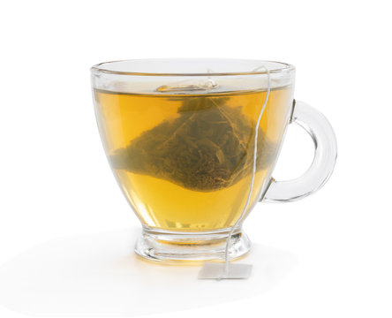 Cup of green tea with jasmine and pyramid tea bag isolated on white