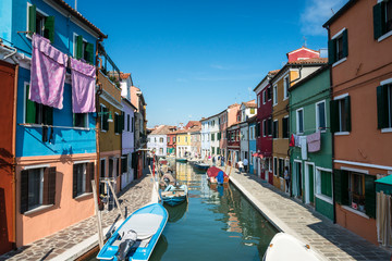 Fototapeta na wymiar Colourfully painted houses facade on Burano island on sunny day, province of Venice, Italy