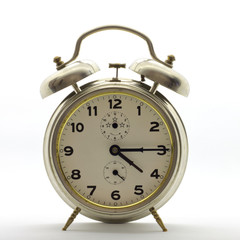 Old-style alarm clock, metal, it's quarter past four. 