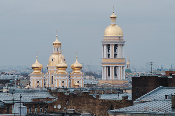 St Petersburg, Russia - Vladimir Cathedral after the restoration of domes on the background of roofs, wires and cloudy sky