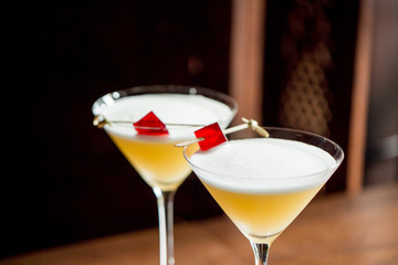 Two alcoholic cocktails in a martini glass