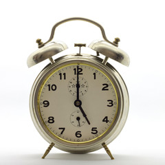 Old-style alarm clock, metal, it's five o'clock.