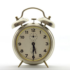 Old-style alarm clock, metal, it's half past five.