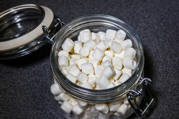 Beautiful white marshmallow in a glass jar closeup