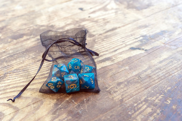 Fototapeta na wymiar Set of blue color dice for board games dnd and rpg on vintage wooden table. With your place for the text