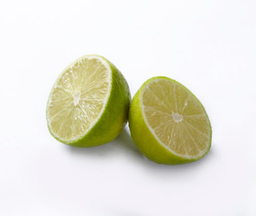 Natural fresh lime with water drops and slice of green lime citrus fruit stand isolated on white background.