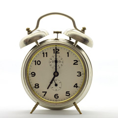 Old-style alarm clock, metal, it's seven o'clock.