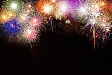 Several fireworks stacked. In the middle of the space, write a message Happy New Year.