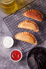 Mexican corn chips nachos and fried meat pies empanadas cheburek with dips. Black chips nachos for brutal men.