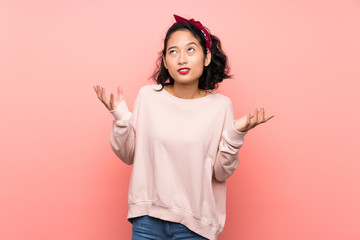 Asian young woman over isolated pink background frustrated by a bad situation