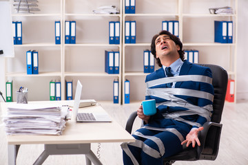 Young tied male employee in the office