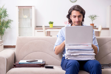 Young male employee working at home