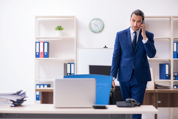 Young male businessman working in the office