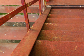 metal stairs. abandoned urban background full of rusty texture. view downside