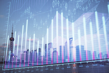 Forex graph on city view with skyscrapers background double exposure. Financial analysis concept.