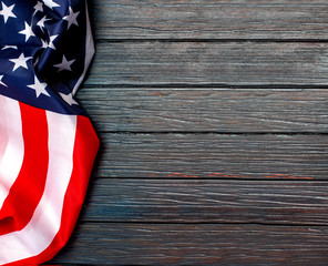  US flag on wooden background.