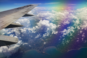 Fototapeta premium Airplane wing, clouds and sky during the flight. Shot with a polarizing filter for the lens.