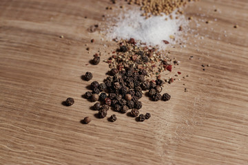 Fragrant spices are scattered on a white oak kitchen board. The main helpers of the cook in the...