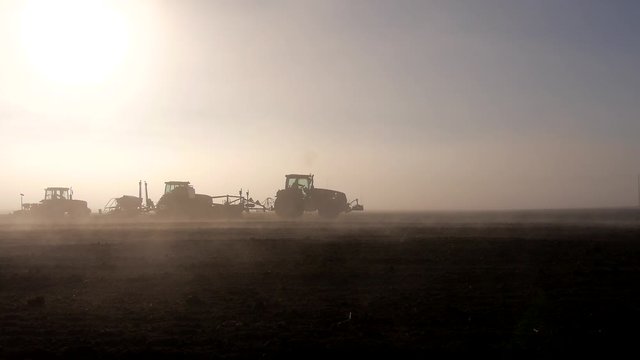 stock footage tractor in a field, the morning mist