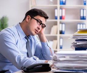 Fototapeta premium Extremely busy businessman working in office