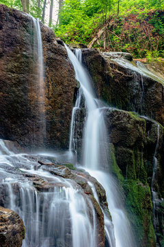 waterfall skakalo in the forests of transcarpathia. rapid water stream runs down the huge boulders. clear water of carpathian nature in springtime. long exposure