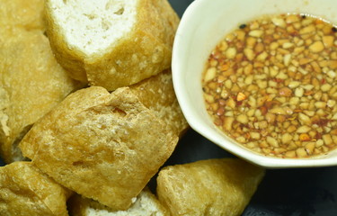 deep fried tofu dipping with sweet crushed bean sauce on plate