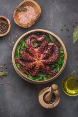 Big boiled octopus with lemon and parsley, copy space