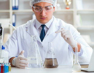 Young researcher scientist doing a water test contamination expe