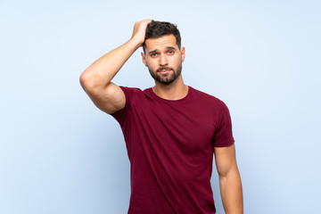 Handsome man over isolated blue background with an expression of frustration and not understanding