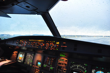 Airbus A320 flight deck from the first officer seat under the rain before starting the engines - obrazy, fototapety, plakaty