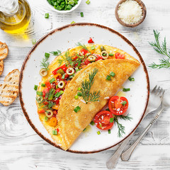 Healthy breakfast food, Stuffed egg omelette with tomato , grilled pepper, green olives and...