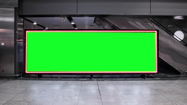 Empty blank widescreen billboard with green screen, alpha channel. Chroma key frame on airport hall, big banner for marketing. 