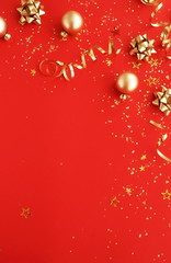 christmas or new year decorations background in gold colors on red  background with empty copy space for text. holiday and celebration concept for postcard or invitation. top view 
