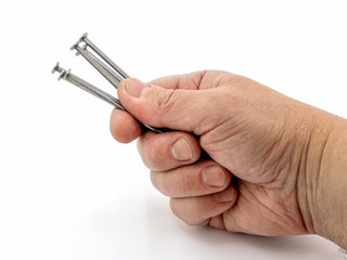 Man holding construction nails in his hand on a white isolated background_