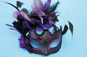 Carnival venetian mask isolated on a blue background. Holiday and masquerade concept.