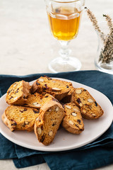 Italian almond biscotti biscuits and sweet wine in a glass on the table. Copy space.
