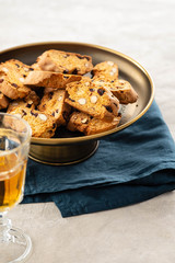 Italian almond biscotti biscuits and sweet wine in a glass on the table. Copy space.